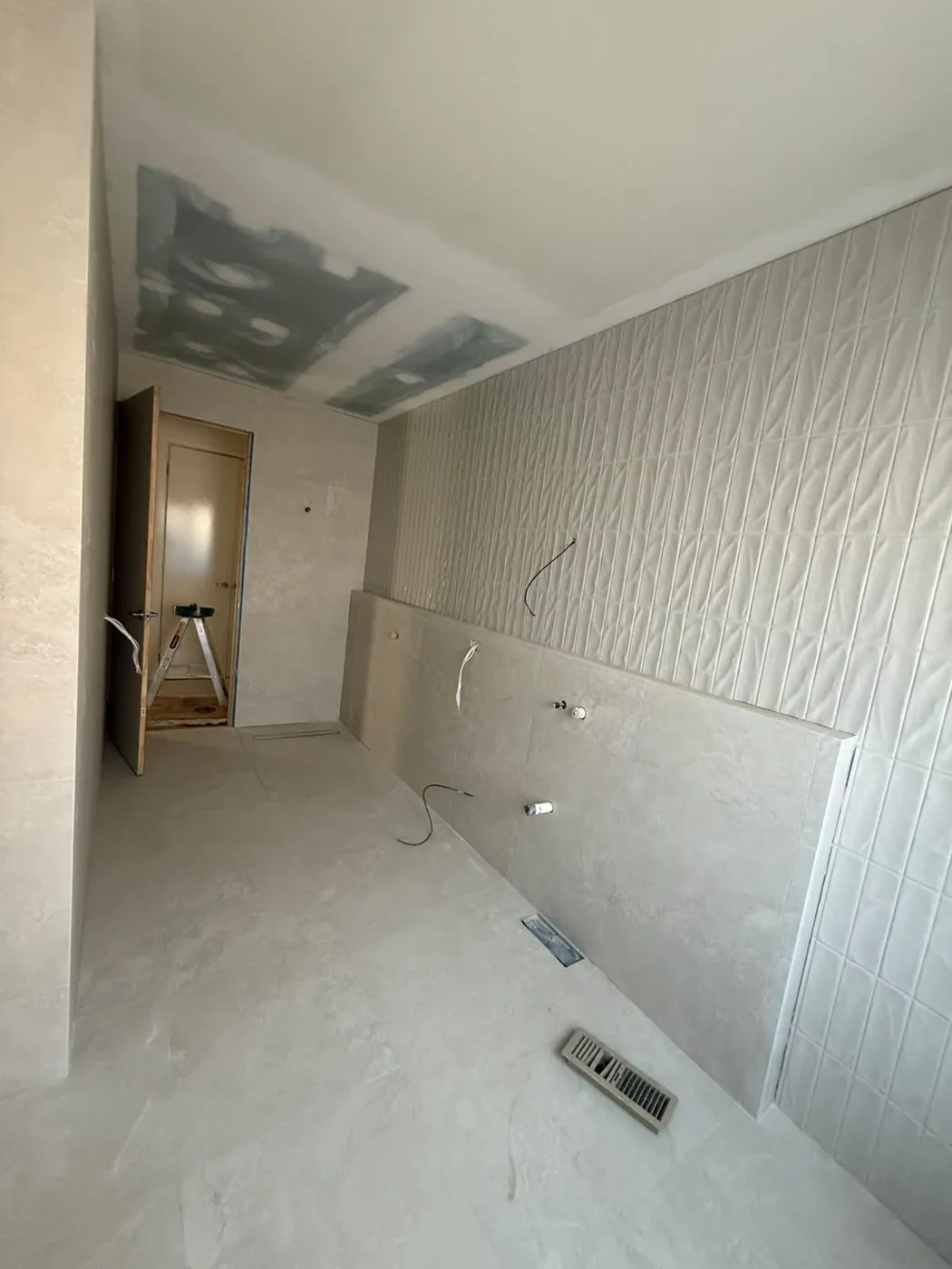 Textured feature wall panel installed during a bathroom renovation